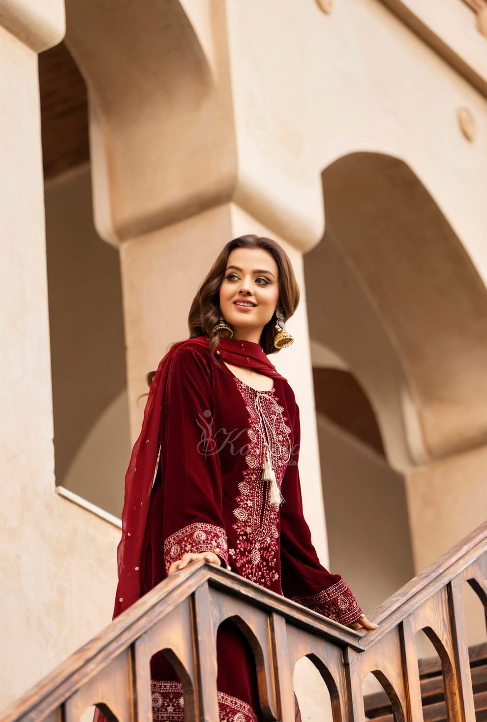 Pakistani women's maroon velvet long kaftan plazo back view